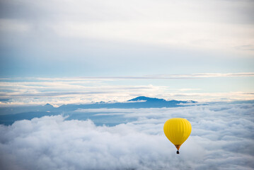Balloon flying over sea of clouds