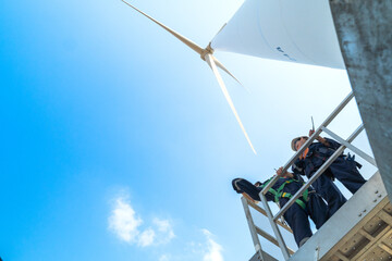 engineers working in fieldwork outdoors. Workers check and inspect construction and machine around the building project site. Wind turbines for electrical clean energy and environment sustainability.
