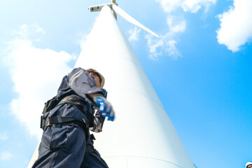 engineer working in fieldwork outdoor. Technicians of wind turbine checking and maintenance Electricity wind generator.. operation of wind turbines that converts wind energy into electrical energy