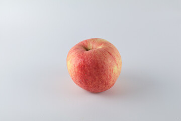 Red apple on white background. Tropical fruit abstract background. Copy space for design or text.