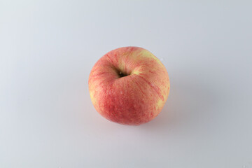 Red apple on white background. Tropical fruit abstract background. Copy space for design or text.