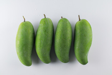Green mango on white background. Tropical fruit. Sour and high vitamin C fruit for healthy.