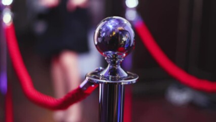 Red carpet with ropes and golden barriers on a luxury party entrance, cinema premiere film festival event award gala ceremony, wealthy rich guests arriving, outdoor decoration elements, summer day