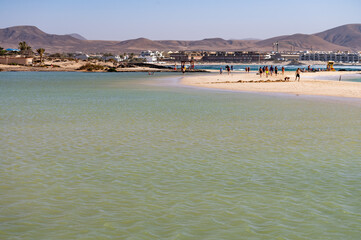 Obraz premium West coast of Fuerteventura island. Winter sea and sun vacation in El Cotillo touristic village, Canary islands, Spain. White sandy beach La Concha..