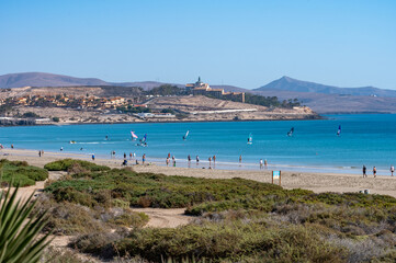 Fototapeta na wymiar Sandy dunes and turquoise water of Costa Calma beach, Fuerteventura, Canary islands, Spain in winter