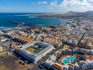 Photo sur Plexiglas les îles Canaries Aerial view Corralejo town, harbour, black rocks, blue water, Lobos and Lanzarote islands, Fuerteventura, Canary islands, Spain