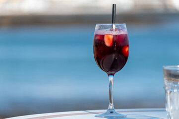 Glass of cold sangria wine served with orange in beach cafe, Corralejo, Fuerteventura, Spain
