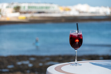 Glass of cold sangria wine served with orange in beach cafe, Corralejo, Fuerteventura, Spain