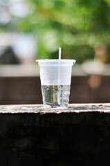 mineral water on a plastic cup with straw