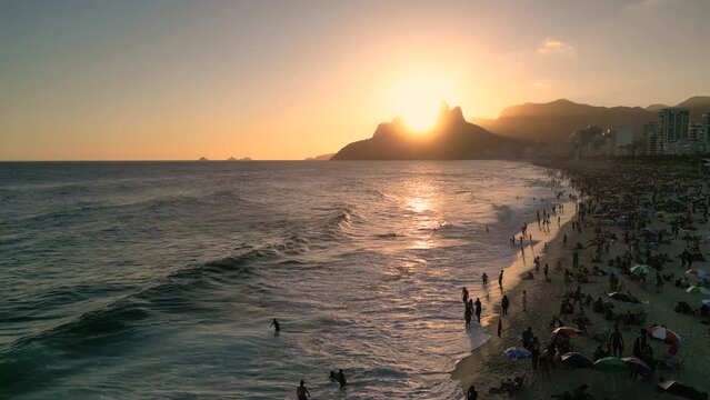 Aerial View of Crowded Ipanema Beach on Sunset and Waves in the Ocean in Rio de Janeiro, Brazil