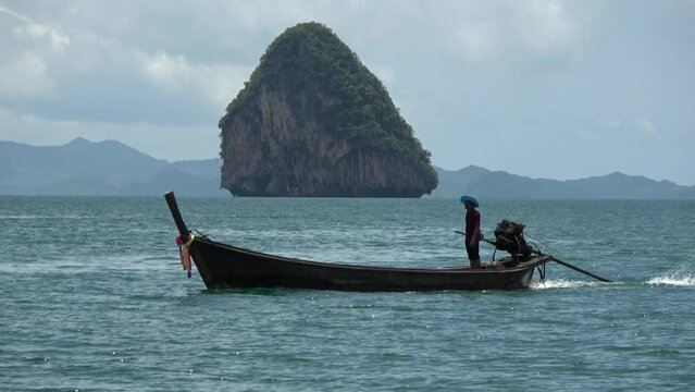 Aerial drone view of long-tail boat in Thai Ruea Hang Yao is type of watercraft native to Southeast Asia which uses common automotive engine as readily available and maintainable powerplant 4k