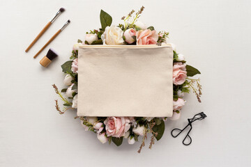 Blank makeup bag mockup with floral detail - flatlay - obrazy, fototapety, plakaty