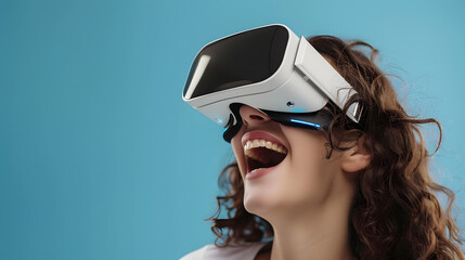 Naklejka premium Young woman student laughing, wearing white augmented virtual reality glasses on a blue studio background with copy space.