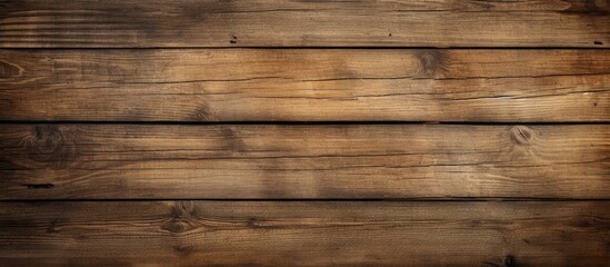 Obraz na płótnie Canvas A close-up view of a wooden wall with a rich brown background. The wall is made up of individual wooden planks that create a textured pattern. The brown color is warm and earthy, adding a sense of