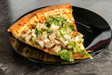 Slice of chicken Caesar salad pizza