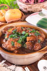 Stewed pork trotters in brown sauce in clay pot
