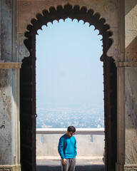 Person standing in old vintage door of a palace at Udaipur Rajasthan India 