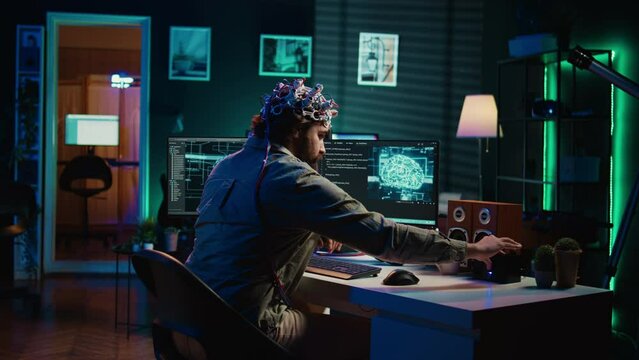 IT specialist using EEG headset and deep learning technology to upload brain into computer. Close up of neuroscientific equipment used by man transferring consciousness into cyberspace, camera B