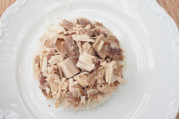 Boiled chicken, steamed rice, pink plate.