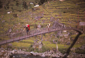 Hiker on narrow suspension bridge
