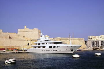 Luxury yacht and medieval Fort San Angelo