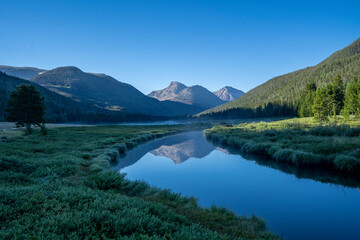 Naklejka premium Rocky Mountain meadow with river reflection in Utah