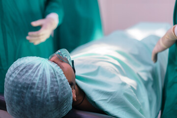 Patient on plastic surgery at operating room in hospital. A patient waits in a bed preparing for...