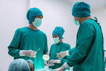 Medical team doing critical operation. Group of surgeons in operating room with surgery equipment at hospital.