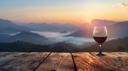 Fotobehang Empty wooden table with mountain view, light mist and glass of wine in the morning. © somchai20162516
