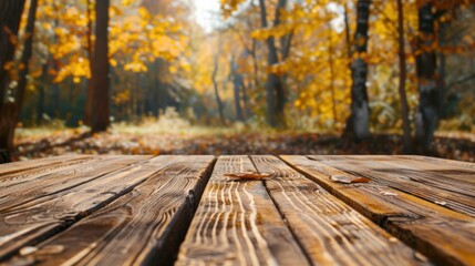 Naklejka na ściany i meble Empty rustic wooden table for displaying products with blurred background of autumn forest.