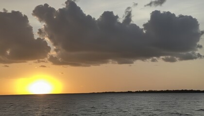 Fototapeta premium Sunset over the ocean, with a dramatic sky