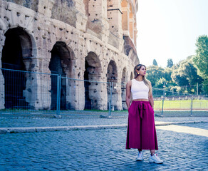 Fototapeta na wymiar young woman posing next to the Roman colosseum