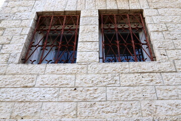 Fototapeta na wymiar A small window as an architectural detail in the construction of residential buildings in Tel Ayiv.