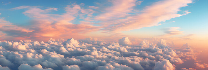 Voluminous Clouds Illuminated by a Warm Glow Set Against a Distant Landscape in a Majestic Sky