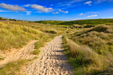 Sandy path - the South West Coast Path passes through sand dunes near Holywell Bay, Cornwall, UK.