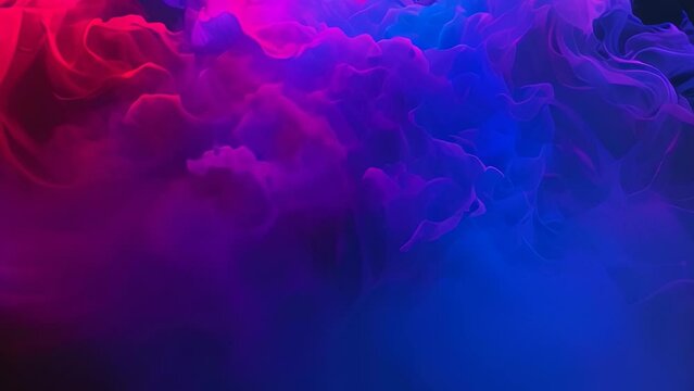 Video animation of mesmerizing blend of smoke or clouds, illuminated with vibrant colors transitioning from red to purple and then to blue.