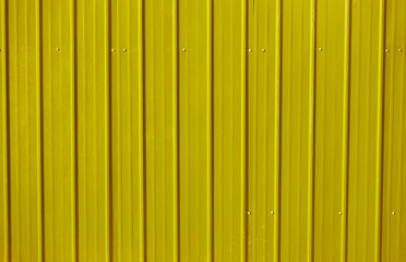 yellow metal decking. new, modern Sheets of yellow corrugated iron.  Texture of green metal fence, roofing.