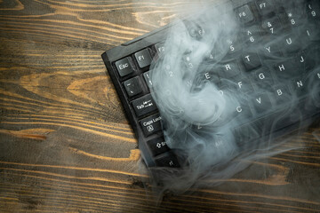 Closeup view of a computer keyboard with white smoke