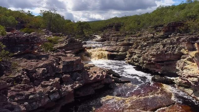 Aerial view of a waterfall and a river in the middle of a big vegetation, Chapada Diamantina, Bahia, Brazil
