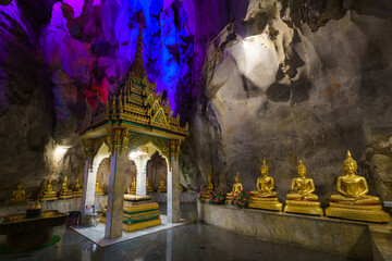 
The golden Buddha statues are placed inside a cave at Tham Khao Yoi Temple in Phetchaburi...