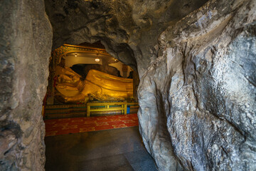 
The golden Buddha statues are placed inside a cave at Tham Khao Yoi Temple in Phetchaburi Province. It's a beautiful tourist attraction in Thailand.