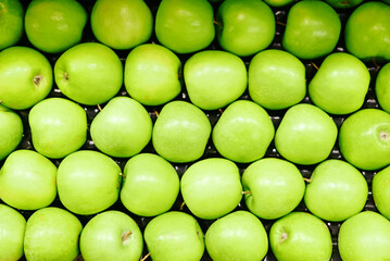 Top view row of fruits green apples in the store