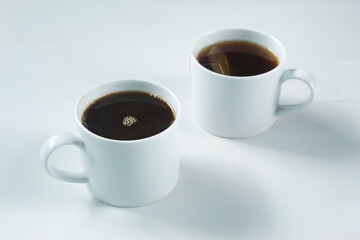 a cup of black coffee and hot tea