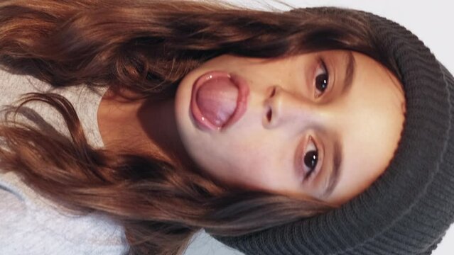 Vertical tongue out child grimacing kid girl