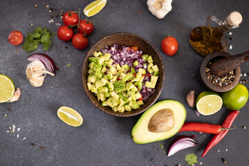 Cooking traditional salsa - sliced chopped ingredients in a wooden bowl