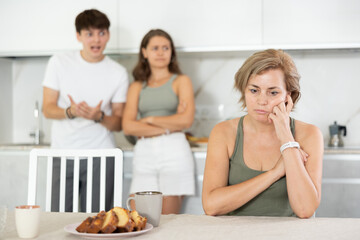 Portrait of thoughtful woman who had conflict with adult children while cooking dinner in home kitchen