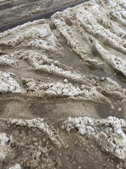 Traces from car wheels in the snow in winter as a background