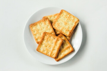 a plate of crispy cracker biscuits, on a white background