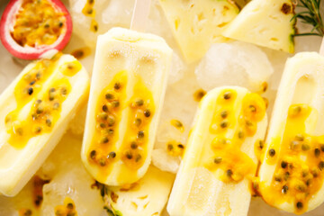 Pineapple popsicles with fresh passion fruit in ice tray.