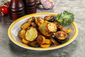 Roasted young zucchini in the plate